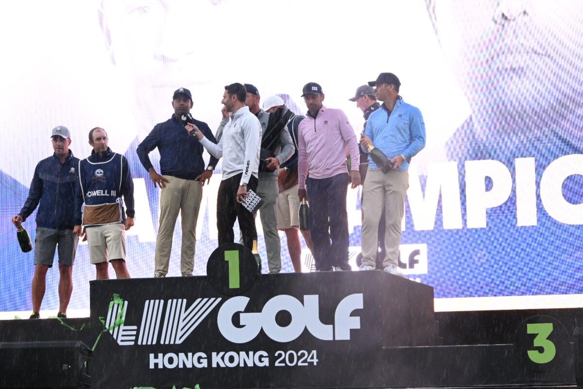 Team Crushers comprising Paul Casey, Bryson DeChambeau (captain), Charles Howell III, and Anirban Lahiri, on the Hong Kong LIV Golf team winner's podium on March 10, 2024. (Bill Cox/The Epoch Times)