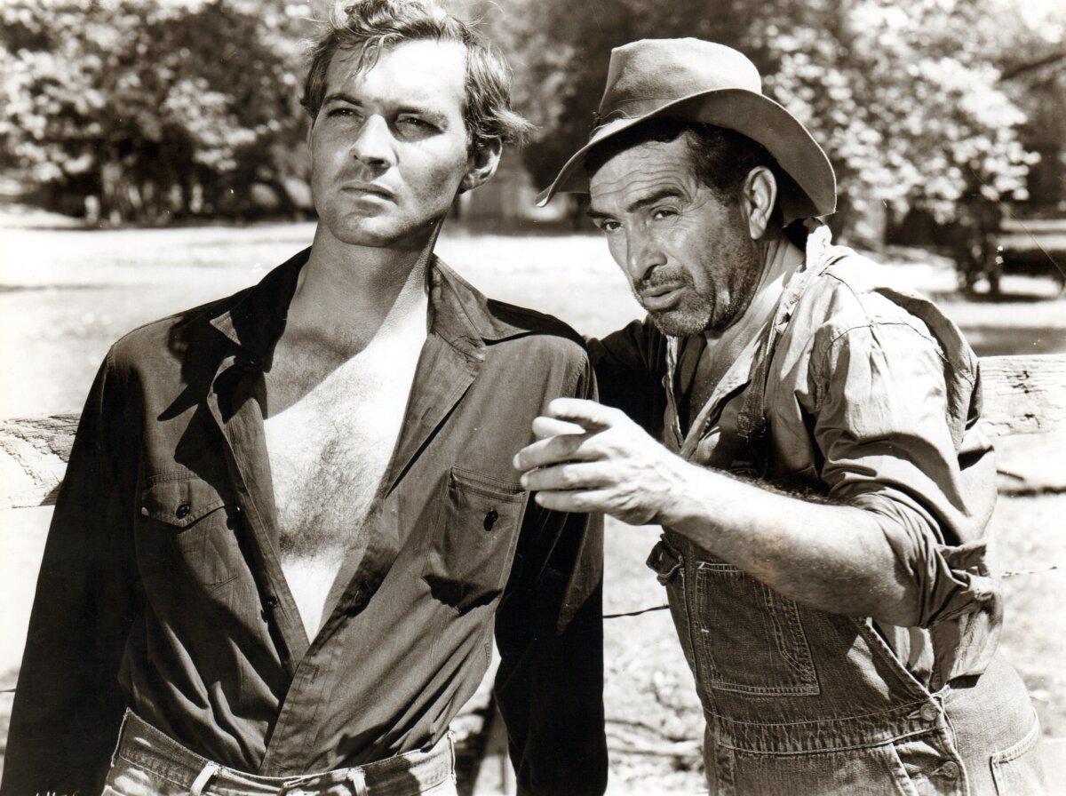 Texan Sam Tucker (Zachary Scott, L) and neighboring farmer Henry Devers (J. Carrol Naish), in “The Southerner.” (United Artists)