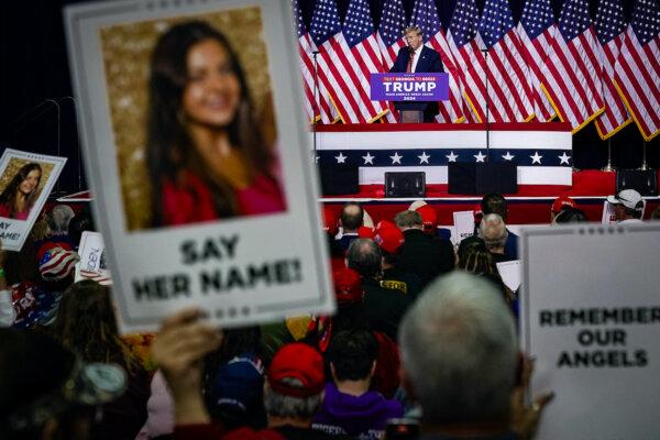 Former President Donald Trump speaks as supporters hold images of Laken Riley during a campaign event in Rome, Ga., on March 9, 2024. (Elijah Nouvelage/AFP via Getty Images)