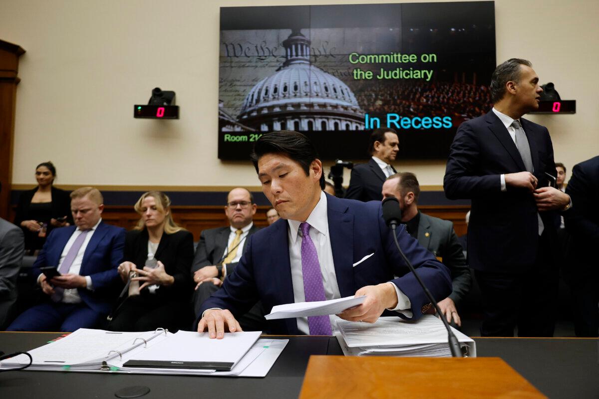 Former Special Counsel Robert Hur assembles his materials during a break in testimony before the House Judiciary Committee in Washington on March 12, 2024. (Chip Somodevilla/Getty Images)