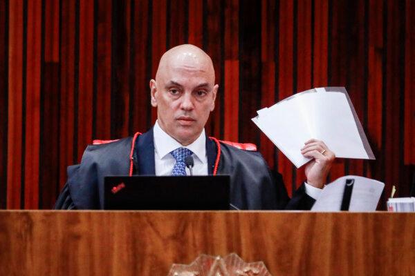 Brazil's Superior Electoral Court President Alexandre de Moraes holds documents during the fourth day of the trial of Brazilian former President Jair Bolsonaro, accused of abuse of power and misinformation, in Brasília, on June 30, 2023. (Sergio Lima/AFP via Getty Images)