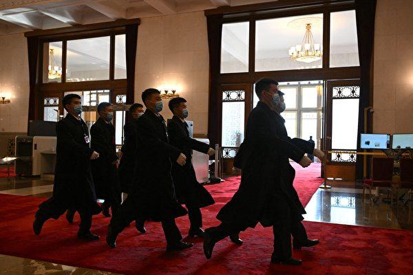 Security members walk past an entrance during the Chinese People's Political Consultative Conference (CPPCC) closing ceremony at the Great Hall of the People in Beijing on March 10, 2024. (Jade Gao/AFP via Getty Images)