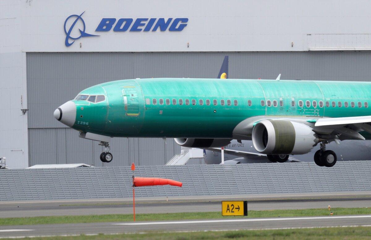A Boeing 737 Max 8 airplane lands following a test flight at Boeing Field in Seattle on April 10, 2019. (Ted S. Warren/AP Photo)