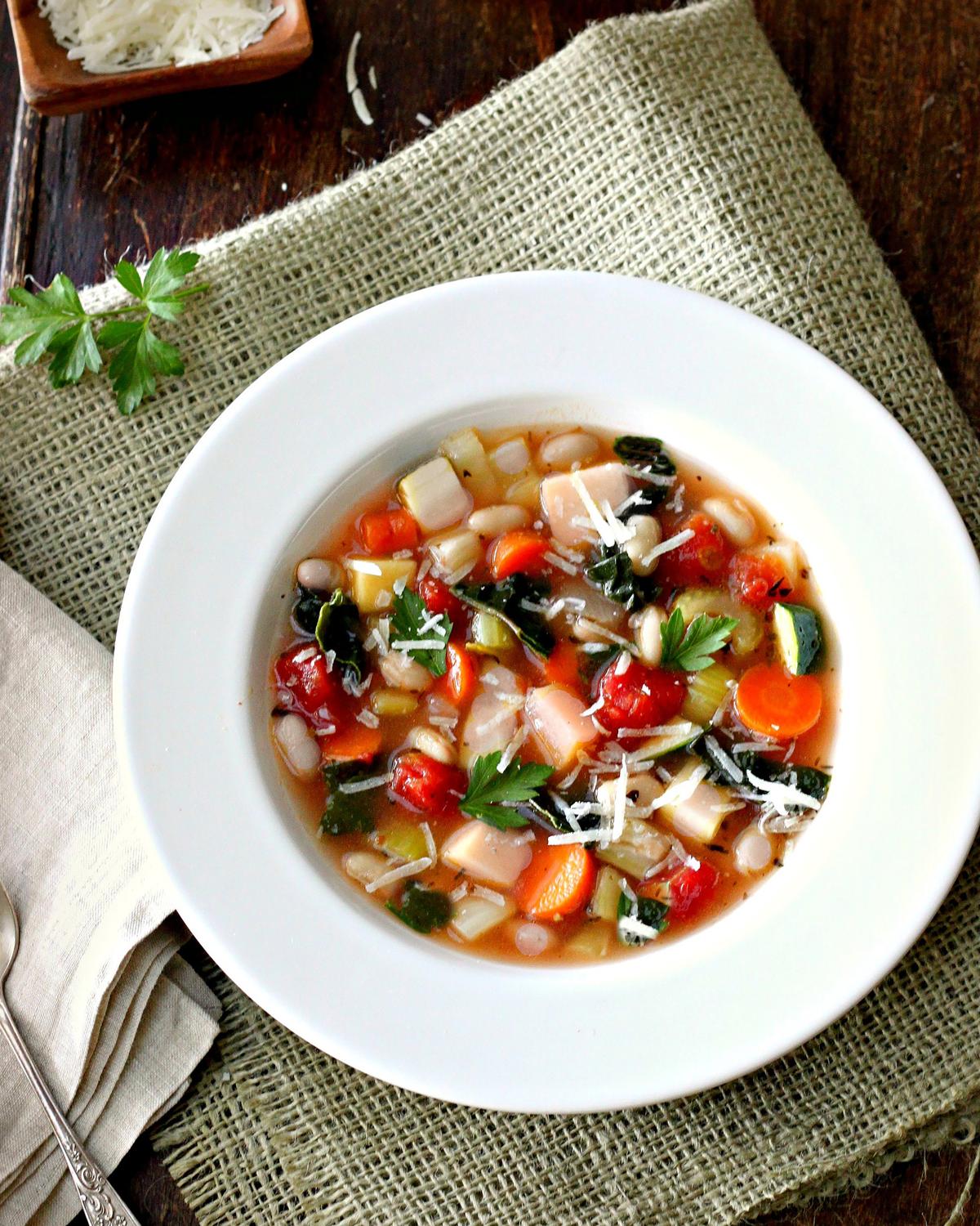 A bright tomato-based broth and hearty white beans are staples of this adaptable recipe. (Lynda Balslev for Tastefood)