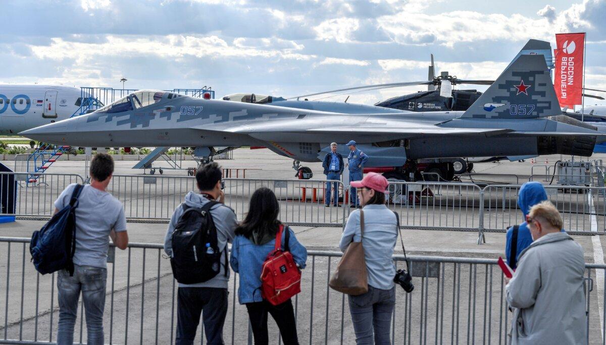 Visitors look at the Sukhoi Su-57 fifth-generation fighter during the MAKS-2019 International Aviation and Space Salon opening ceremony in Zhukovsky outside Moscow, on Aug. 27, 2019. (Alexander Nemenov/AFP via Getty Images)