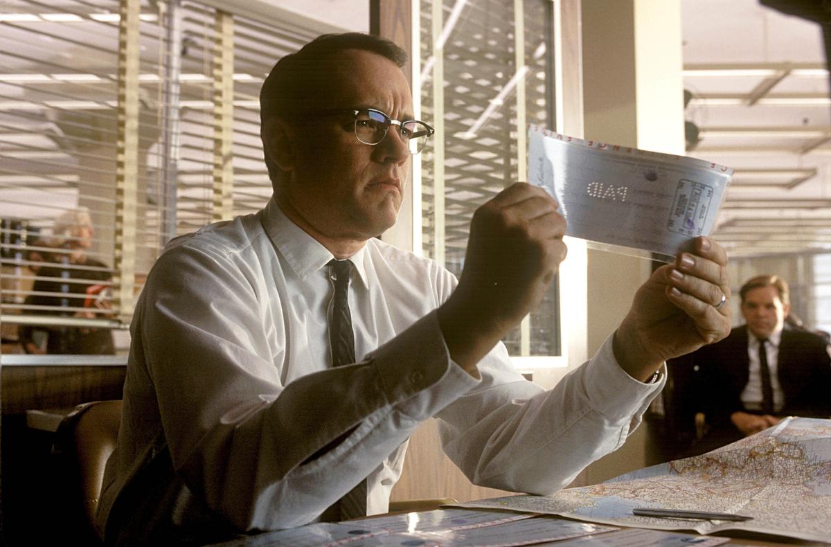 Counterfeiters can produce very realistic checks, complete with watermarks, making close inspection a must. A scene from the film “Catch Me If You Can,” where Tom Hanks plays an FBI agent trying to track down a con artist played by Leonardo DiCaprio. (MovieStillsDB)