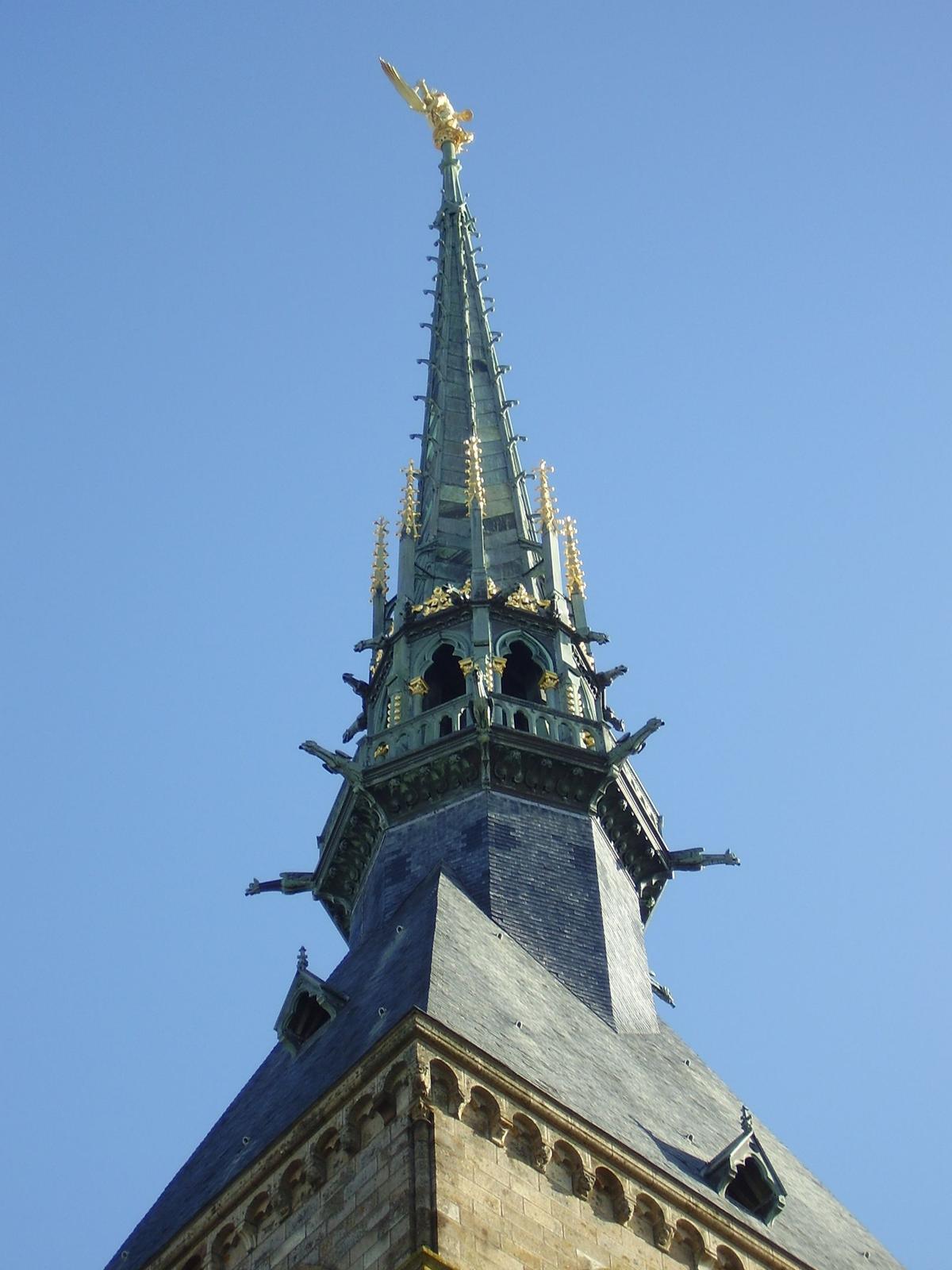 The statue of the Archangel Michael crushing the evil dragon under his feet stands atop a lofty spire that soars 300 feet towards the heavens. (Kamel15/CC BY-SA 3.0 DEED)