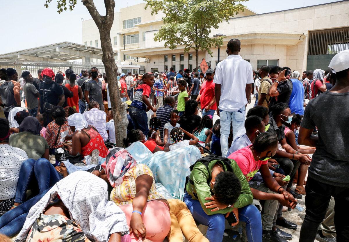 Haitians gather outside the U.S. Embassy after the assassination of President Jovenel Moise, in Port-au-Prince, Haiti July 9, 2021. (Estailove St-Val/Reuters)