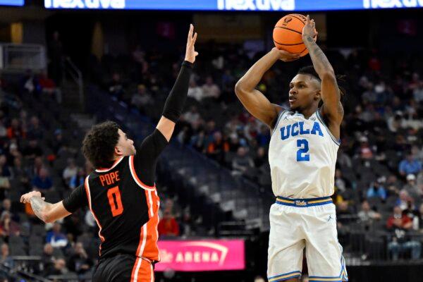 Dylan Andrews (2) of the UCLA Bruins shoots over Jordan Pope (0) of the Oregon State Beavers during the first half of a first round game in the Pac-12 Conference basketball tournament in Las Vegas on March 13, 2024. (David Becker/Getty Images)