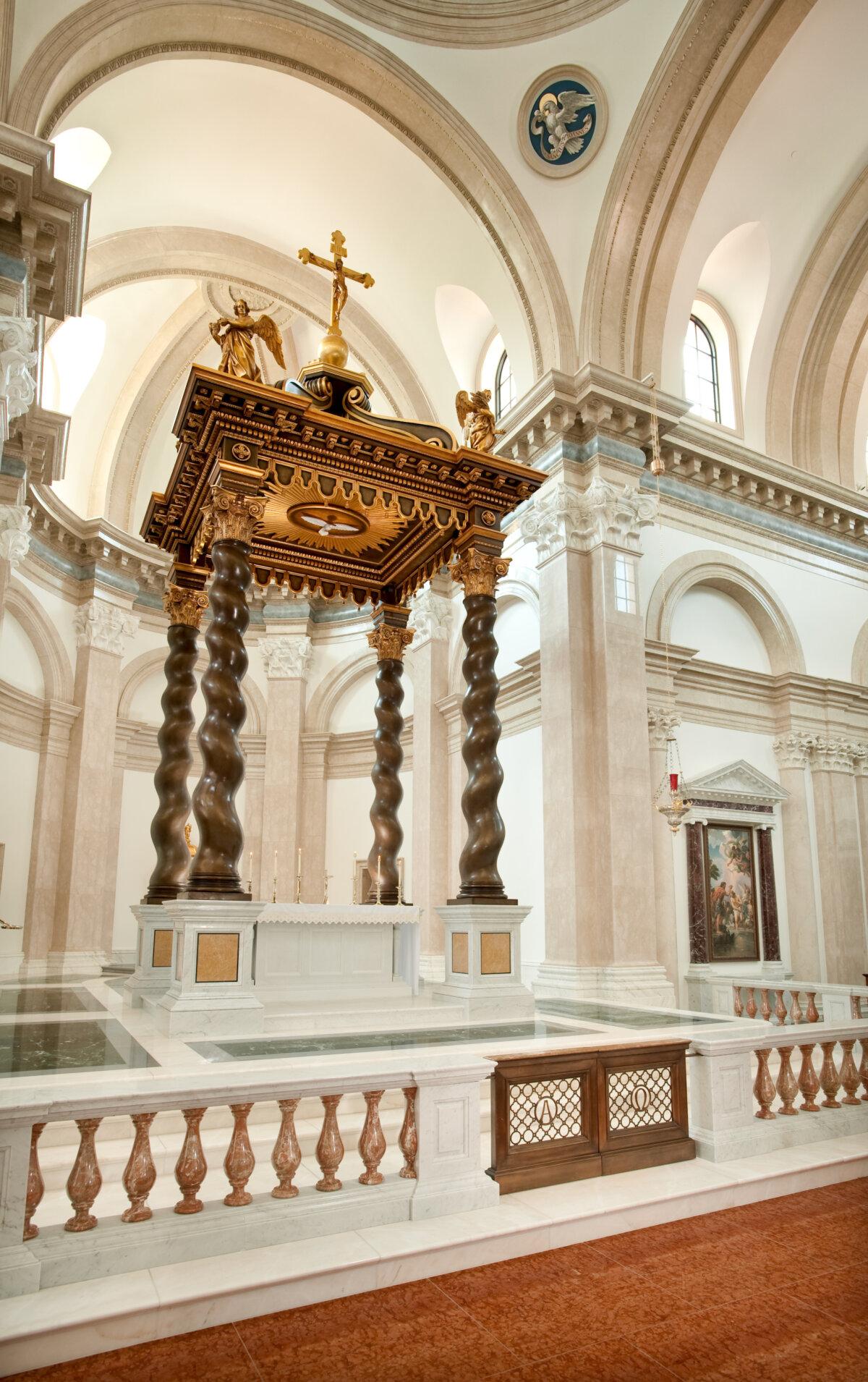 The centerpiece baldacchino, or canopy, traditionally placed over a church altar, is 34 feet high. Four Solomonic [referring to columns in the temple of Jerusalem during the reign of King Solomon] bronze columns are aesthetically curled to support a cover with elaborate and gilded details. The baldacchino’s design was inspired by one at St. Peter’s in Rome. (Courtesy of Thomas Aquinas College)