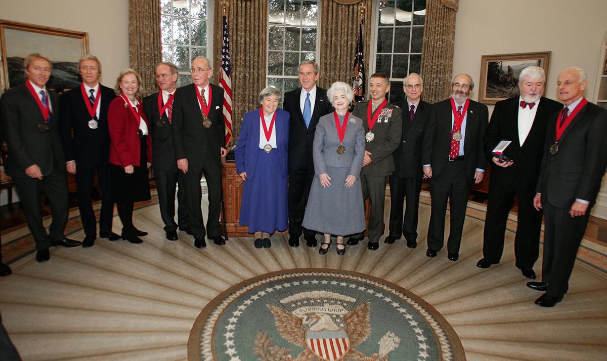 Eva Brann (to the left of former president George W. Bush) poses for a picture after being presented with a National Humanities Medal on Nov. 10, 2005. (Paul J. Richards/Getty Images)