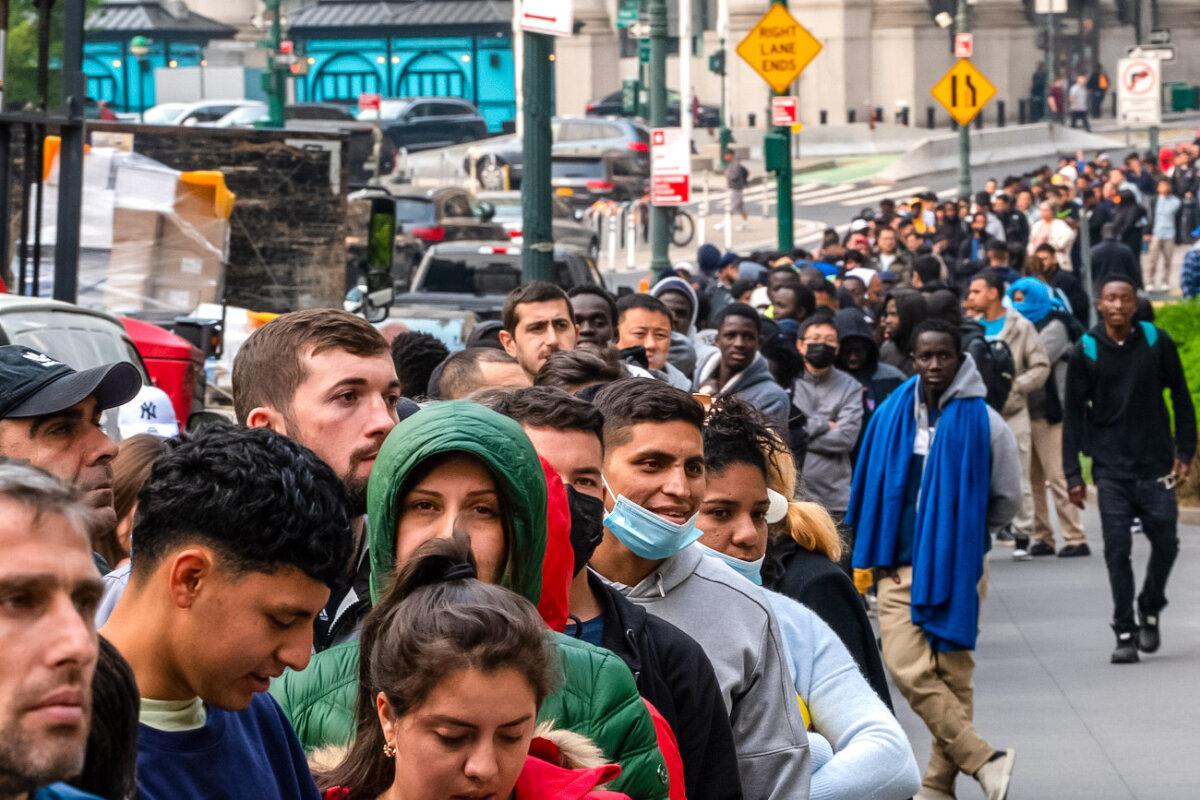Hundreds of migrants line up outside the Jacob K. Javits Federal Building in New York City on June 6, 2023. (David Dee Delgado/Getty Images)