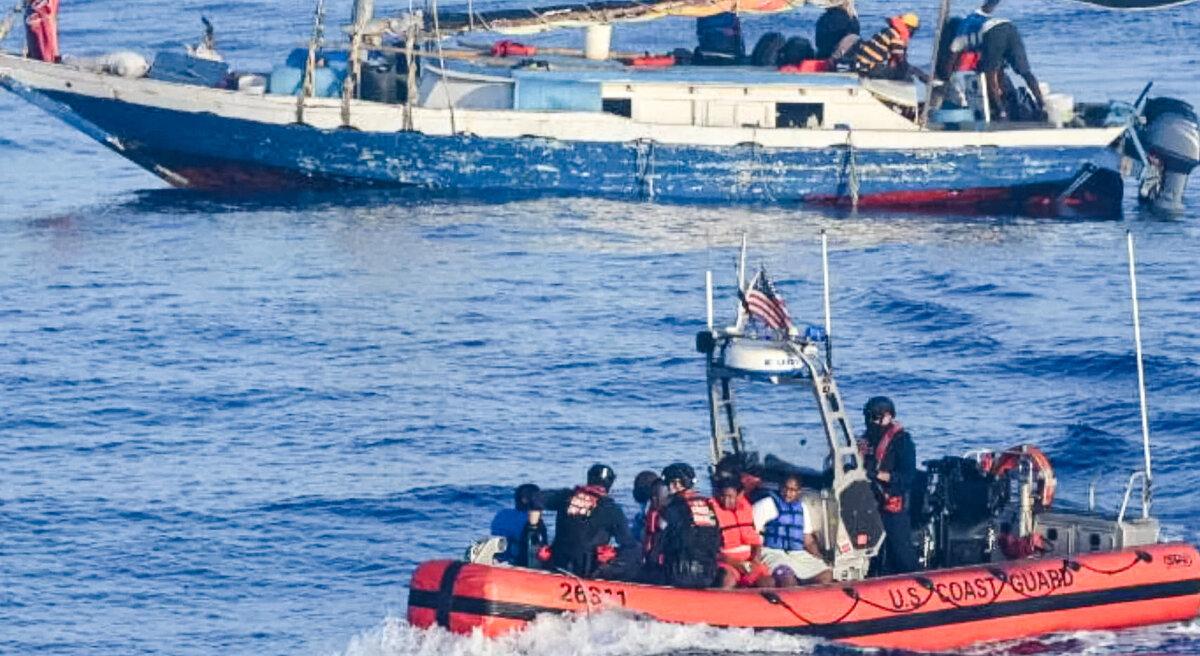 A small U.S. Coast Guard boat ferries Haitians to a larger vessel, 17 miles northeast of Punta Maisi, Cuba, on April 9, 2022. (U.S. Coast Guard photo by Coast Guard Cutter Venturous)
