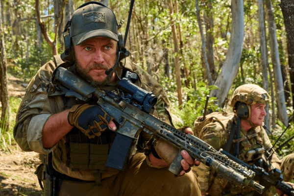 Australian actors and brothers Luke (L) and Liam Hemsworth as a Delta operator and an Air Force JTAC, respectively, in "Land of Bad." (The Avenue/Variance Films)