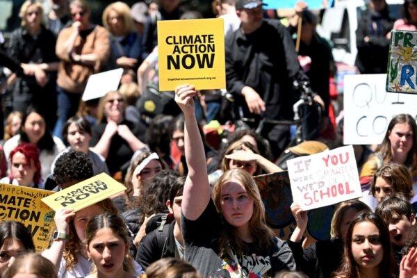 School students hold up placards as they march at a School Strike 4 Climate rally calling for climate action in Melbourne, Australia, on Nov. 17, 2023. (William West/AFP via Getty Images)