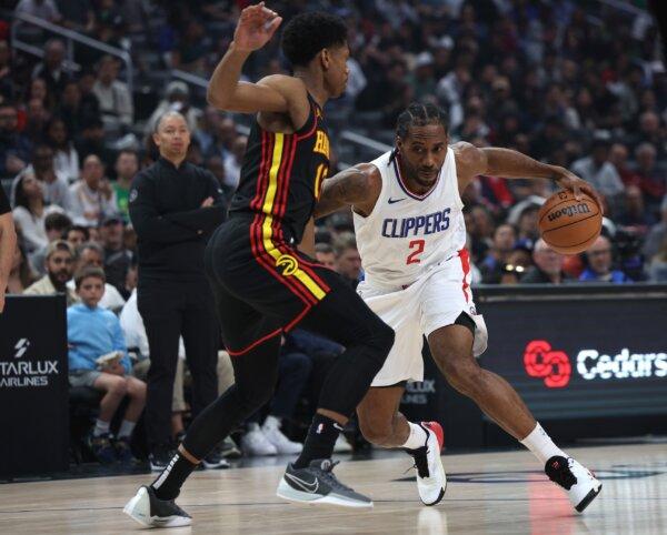 Kawhi Leonard (2) of the LA Clippers drives to the basket on De'Andre Hunter (12) of the Atlanta Hawks during the first half in Los Angeles on March 17, 2024. (Harry How/Getty Images)