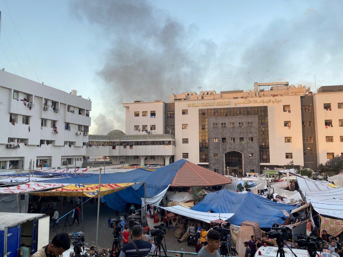 Smoke rises as displaced Palestinians take shelter at Al Shifa hospital, amid the ongoing conflict between Hamas and Israel, in Gaza City, Palestine, on Nov. 8, 2023. (Doaa Rouqa/Reuters)