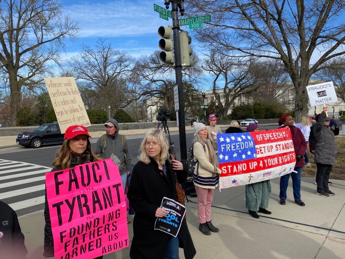 Protesters in support of free speech picket outside the Supreme Court during arguments on March 18, 2024, on whether the Biden administration violated the First Amendment in pressuring social media companies to remove COVID-19 and 2020 election-related content. (Joseph Lord/The Epoch Times)