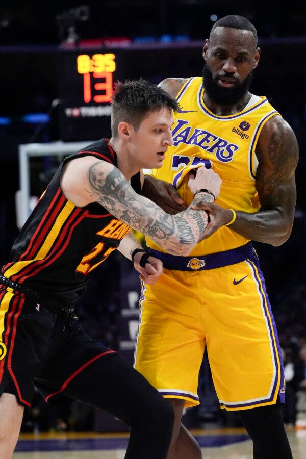 Atlanta Hawks' Vit Krejci (27) defends against Los Angeles Lakers' LeBron James (23) during an NBA basketball game in Los Angeles on March 18, 2024. (Damian Dovarganes/AP Photo)