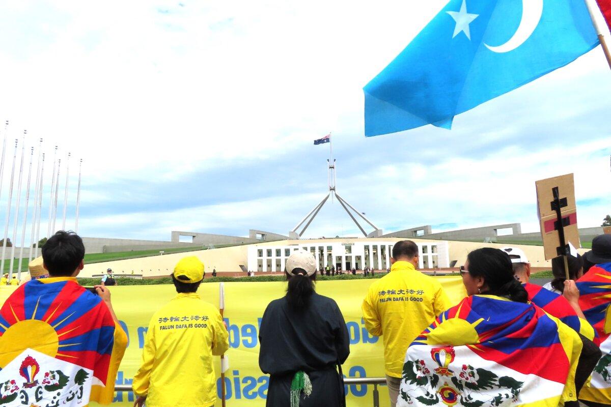 Falun Gong, Tibetan, and Uyghur communities protest CCP Foreign Minister Wang Yi's visit in Canberra, Australia, on March 20, 2024. (Rebecca Zhu/The Epoch Times)