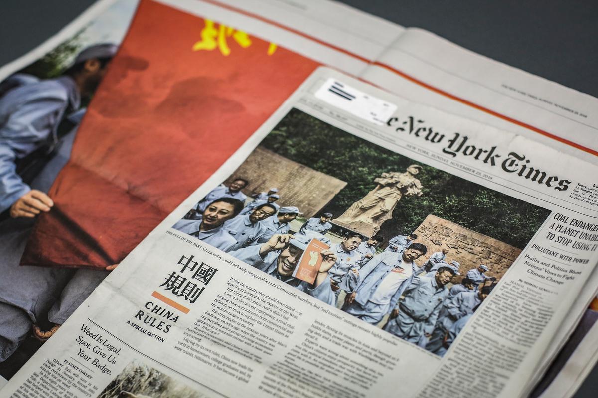 The New York Times published a section called "China Rules" in its Nov. 25, 2018, edition. The section included giant Chinese characters on a red background and a glowing report on the CCP, while simultaneously diminishing the United States. (Samira Bouaou/The Epoch Times)