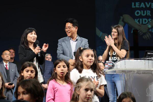 (L-R) Sarah Kim, from TVNext.org, Pastor Shin from Glory Church, and Sarah Stephens, co-founder of Make California Gold Again, on stage at the Time to Stand rally at the Glory Church in Los Angeles on March 16, 2024. (Sophie Li/The Epoch Times)