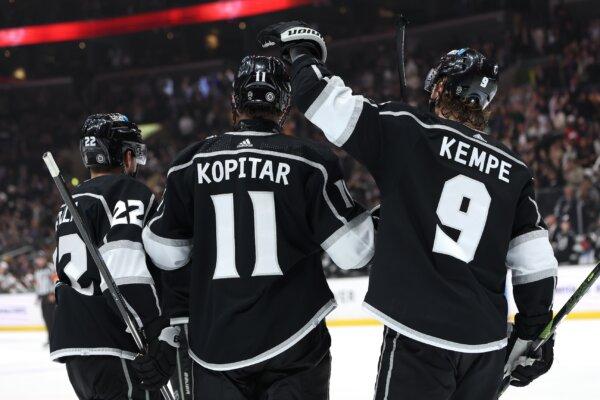 Kevin Fiala (22) and Adrian Kempe (9) congratulate Anze Kopitar (11) of the Los Angeles Kings after his goal during the second period of a game against the Minnesota Wild in Los Angeles on March 20, 2024. (Sean M. Haffey/Getty Images)