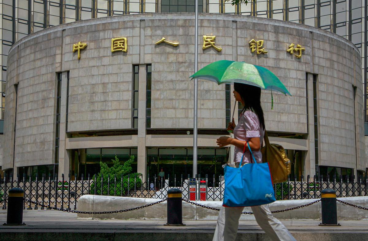 A pedestrian walks past the People's Bank of China, also known as China's Central Bank, in Beijing on Aug. 22, 2007. (Teh Eng Koon/AFP via Getty Images)