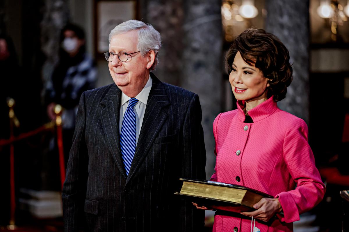 Senate Majority Leader Mitch McConnell (R-Ky.) and wife, Transportation Secretary Elaine Chao, stand in the Old Senate Chambers at the U.S. Capitol on Jan. 3, 2021. (Samuel Corum/POOL/AFP via Getty Images)