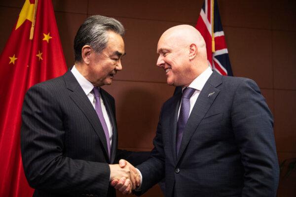 CCP Foreign Minister Wang Yi shakes hands with New Zealand Prime Minister Christopher Luxon in Parliament on March 18, 2024 in Wellington, New Zealand. (Samuel Rillstone - Pool/Getty Images)