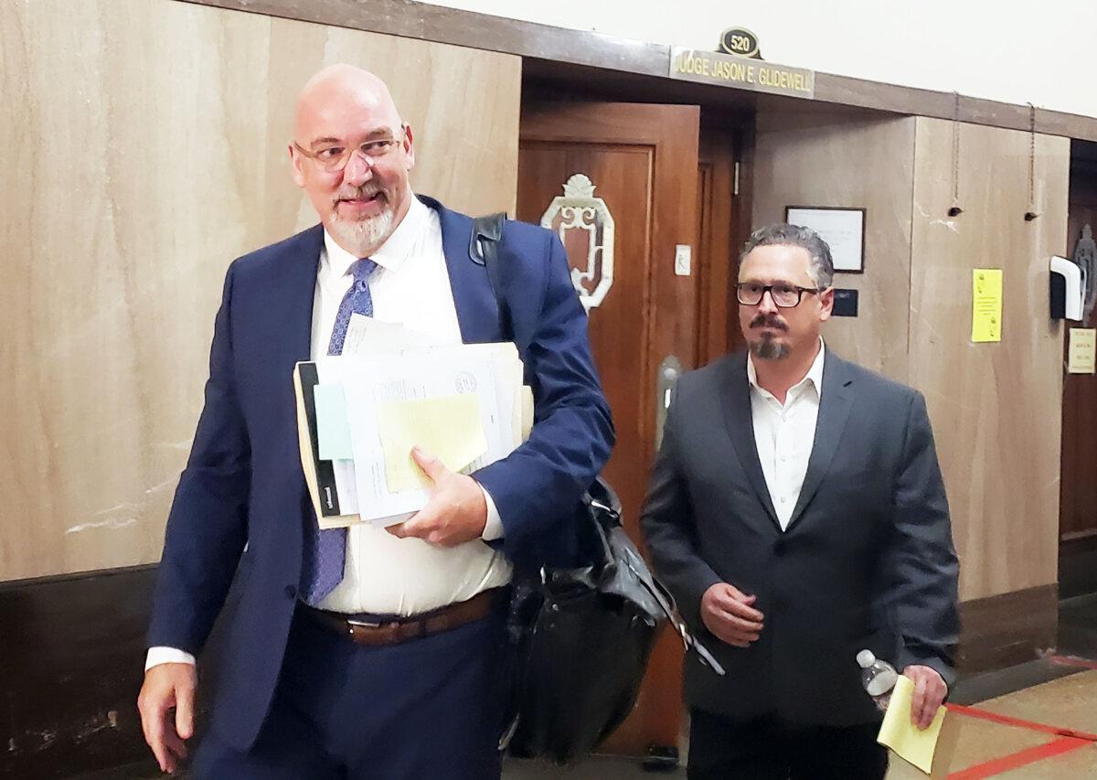 Former Epic Charter School official David Chaney (R) leaves the Oklahoma County District Court in Oklahoma City with his attorney Gary Wood on March 25, 2024. (Michael Clements/The Epoch Times)