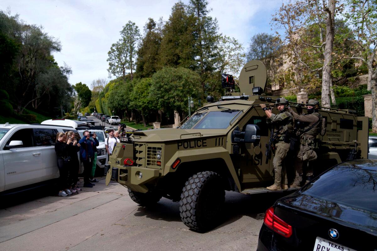 Law enforcement rides a vehicle near a property belonging to Sean "Diddy" Combs in Los Angeles on March 25, 2024. (Eric Thayer/AP Photo)