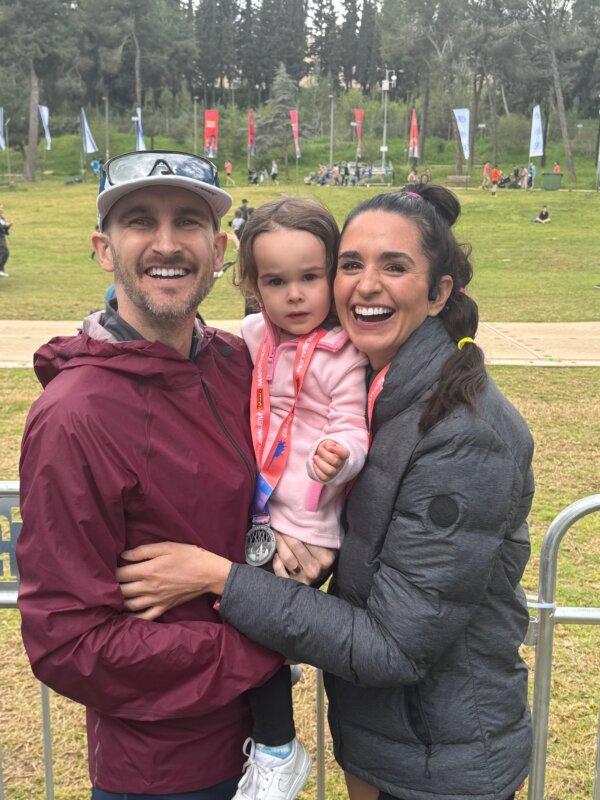 Tyler Underwood (L) and his wife, Kimberly Clark, with their daughter, Clark Underwood, at the Jerusalem Marathon on March 8, 2024. (Dan M. Berger/The Epoch Times.)