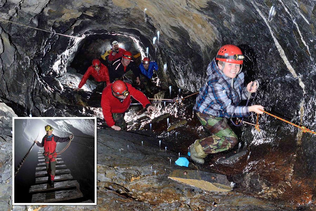 Explorers traverse a wet subterranean passage inside the mine. (Courtesy of <a href="https://www.go-below.co.uk/">Go Below Underground Adventures</a>)
