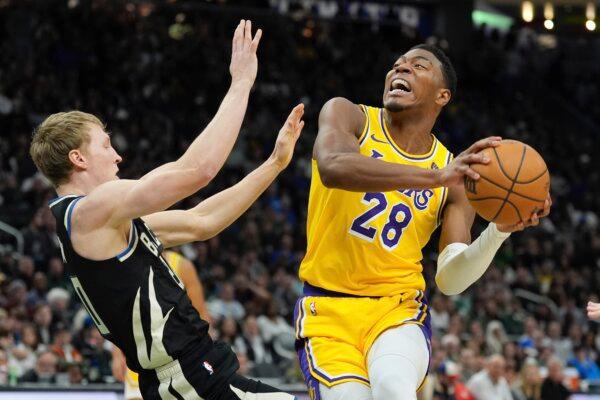 Rui Hachimura of the Los Angeles Lakers tries to get past AJ Green of the Milwaukee Bucks during an NBA game in Milwaukee on March 26, 2024. (Morry Gash/AP Photo)