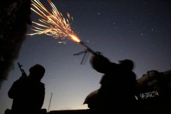 A Ukrainian serviceman fires at a military drone during night combat against Russia-backed separatists on the front line near Novolugansk in the Donetsk region on Nov. 14, 2019. (Anatolii Stepanov/AFP via Getty Images)