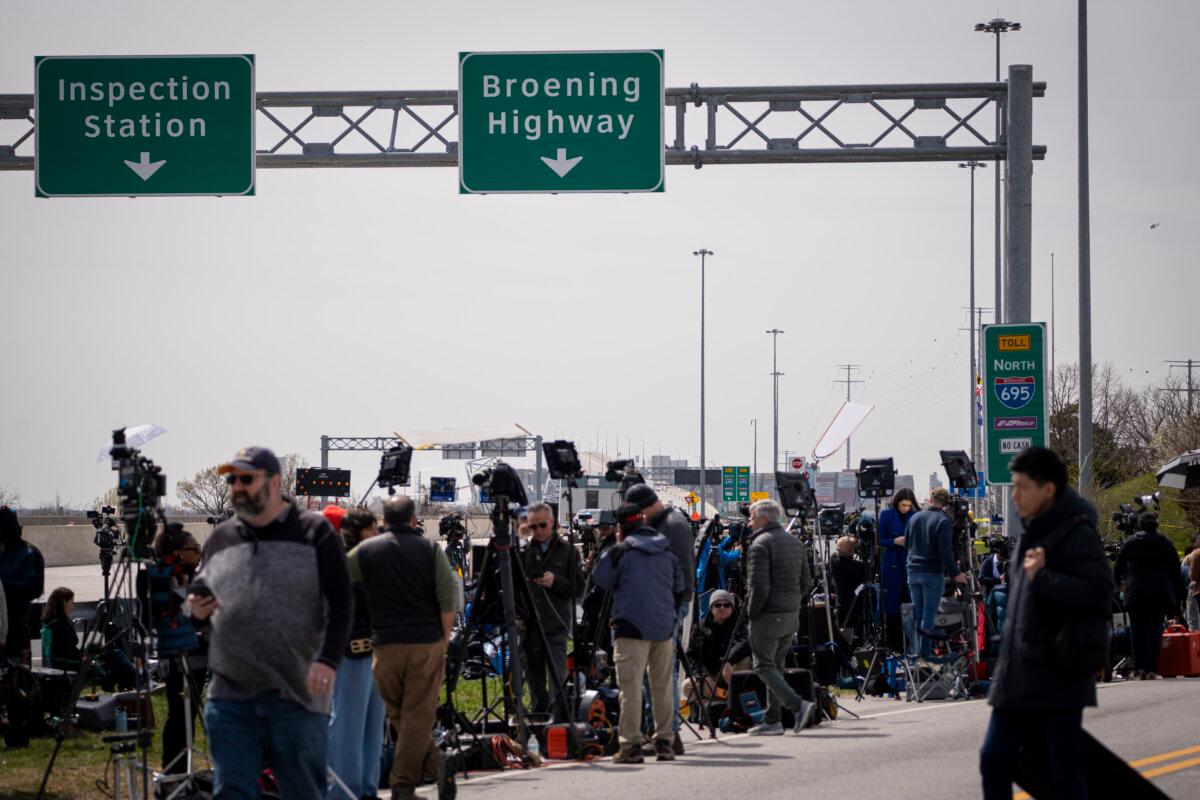Members of the press near the Francis Scott Key Bridge that collapsed after a ship strike in Baltimore on March 26, 2024. (Madalina Vasiliu/The Epoch Times)