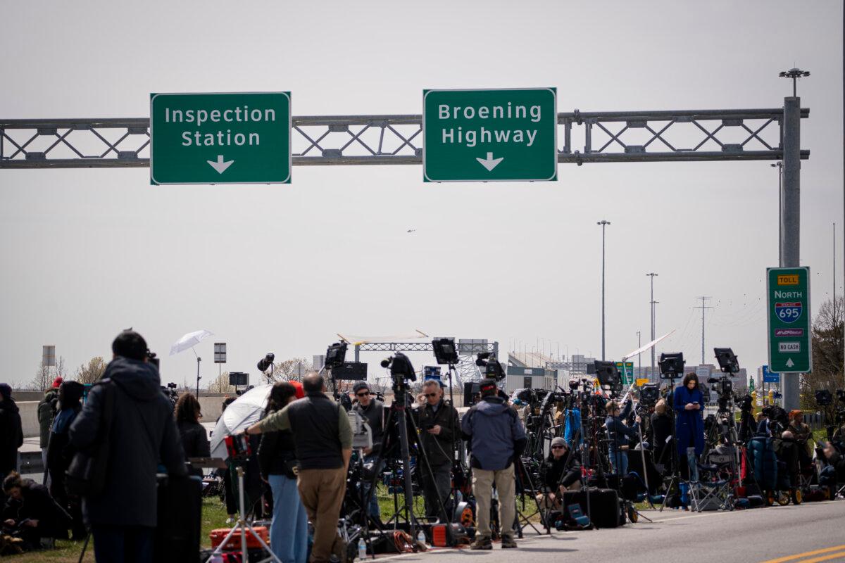 Members of the press near the Francis Scott Key Bridge that collapsed after a ship strike in Baltimore, on March 26, 2024. (Madalina Vasiliu/The Epoch Times)