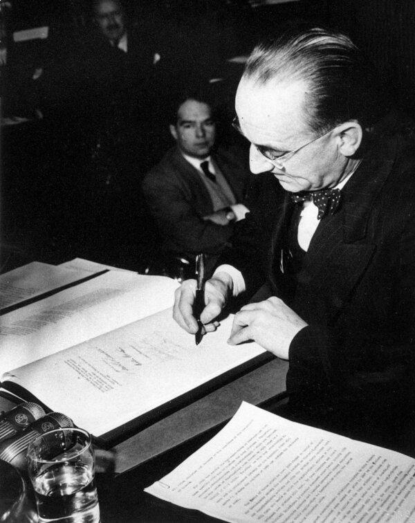 Joey Smallwood signs the terms of union between Newfoundland and Canada in the Senate Chamber in Ottawas on Dec. 13, 1948. Newfoundland officially joined Confederation the following March. (CP Photo)