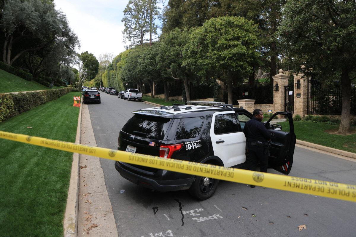 Police cars are seen behind caution tape outside the home of producer and musician Sean 'Diddy' Combs in Los Angeles on March 25, 2024. (David Swanson/AFP via Getty Images)