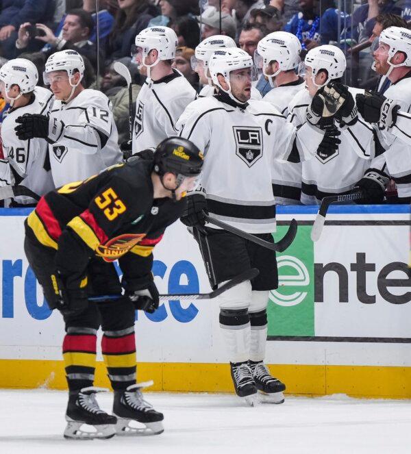 Los Angeles Kings' Anze Kopitar, back right, celebrates his goal as Vancouver Canucks' Teddy Blueger (53) skates to the bench during the second period of an NHL hockey game in Vancouver on March 25, 2024. (Darryl Dyck/The Canadian Press via AP)