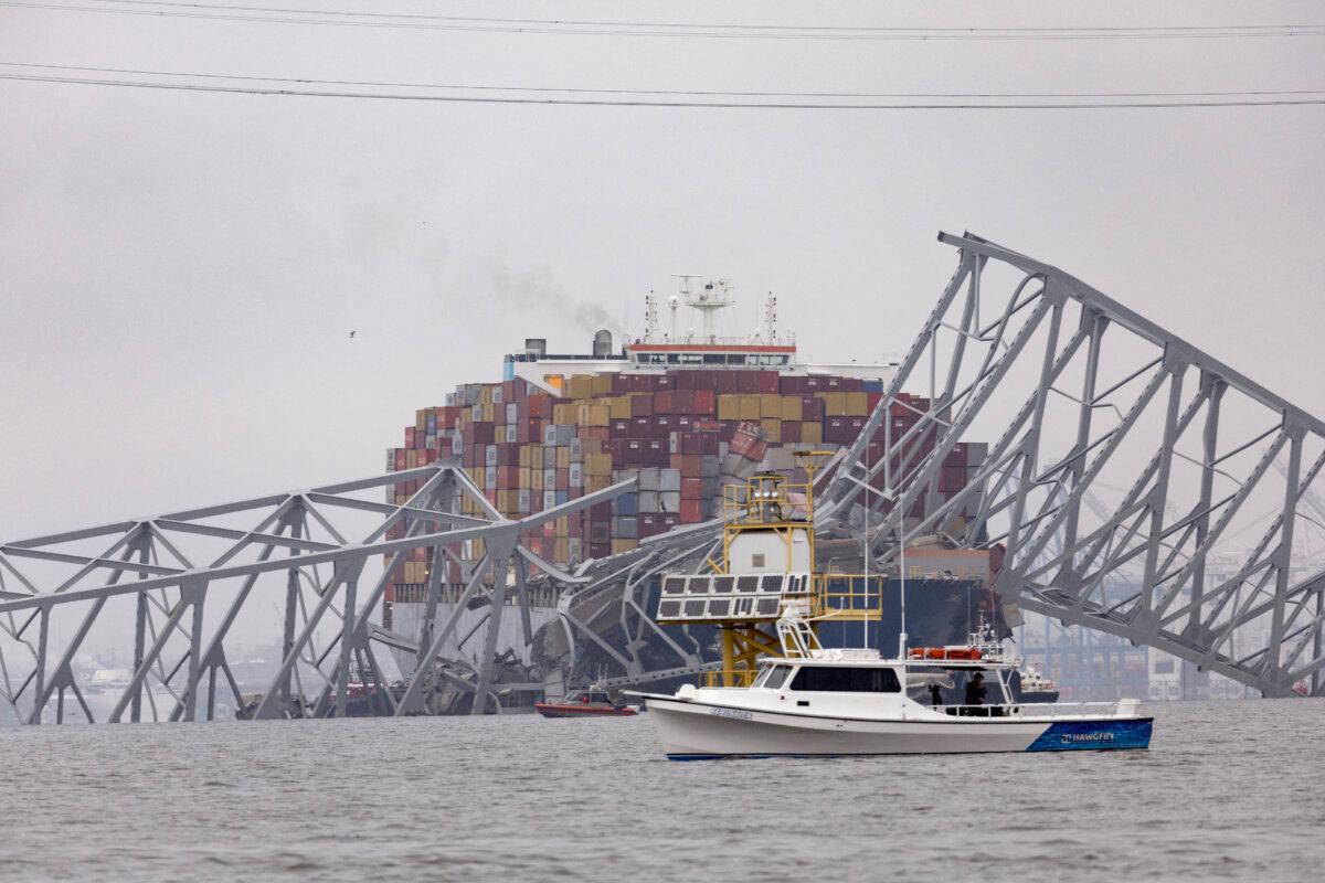Workers continue to investigate and search for victims after the cargo ship Dali collided with the Francis Scott Key Bridge causing it to collapse a day earlier, in Baltimore on March 27, 2024. (Scott Olson/Getty Images)