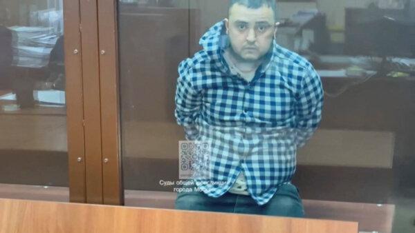 Aminchon Islomov, a suspect in the concert hall attack case, sits behind a glass wall of an enclosure for defendants in a courtroom in Moscow in this still image taken from video released on March 25, 2024. (Moscow City Court's Press Office/Handout via Reuters)