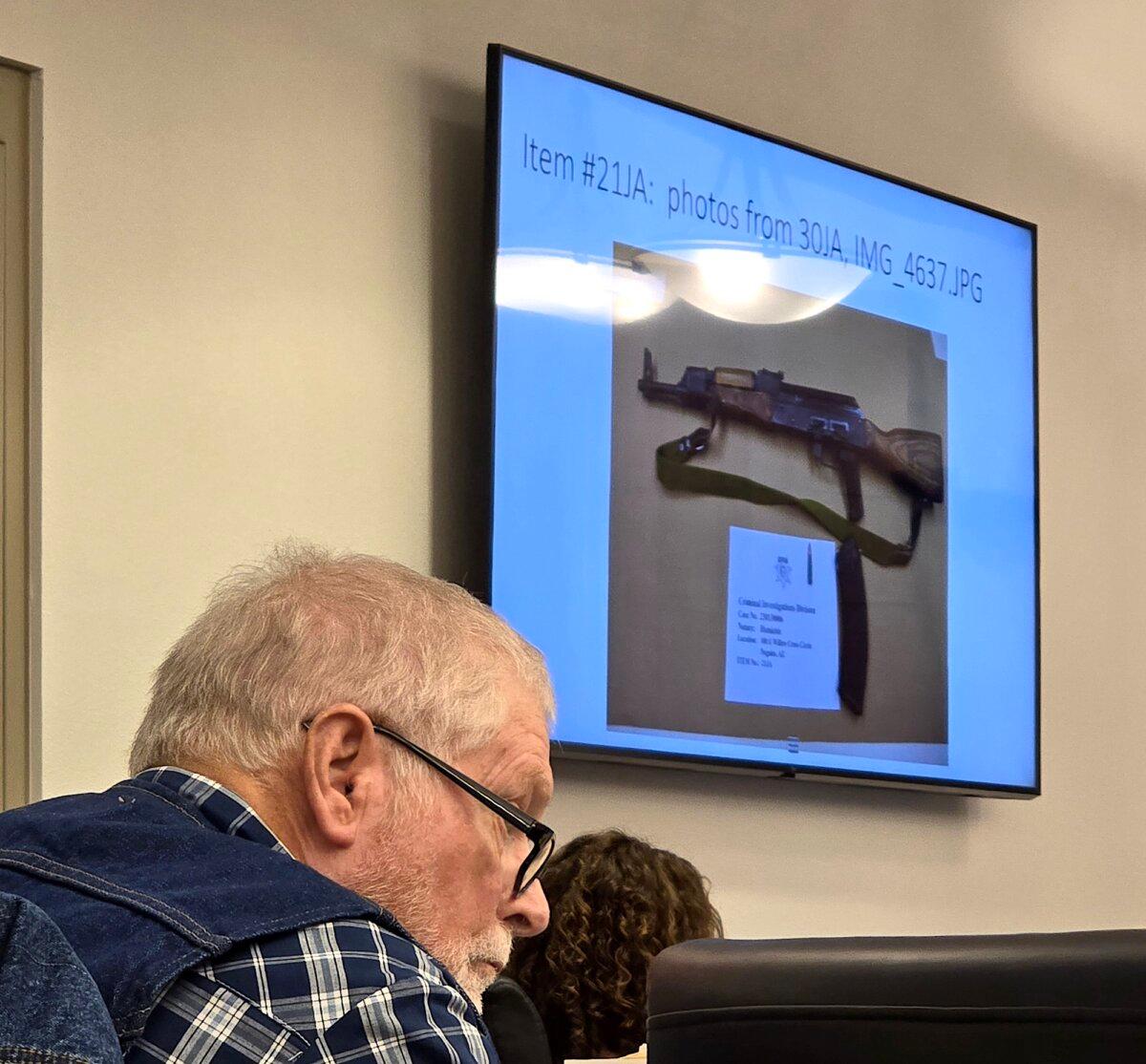 George Alan Kelly, 75, is accused of killing an illegal immigrant with a semi-automatic rifle. A photograph of the AK-47 rifle he allegedly used is shown on a screen as he listens to testimony during his trial in Nogales, Ariz., on March 28, 2024. (Allan Stein/The Epoch Times)