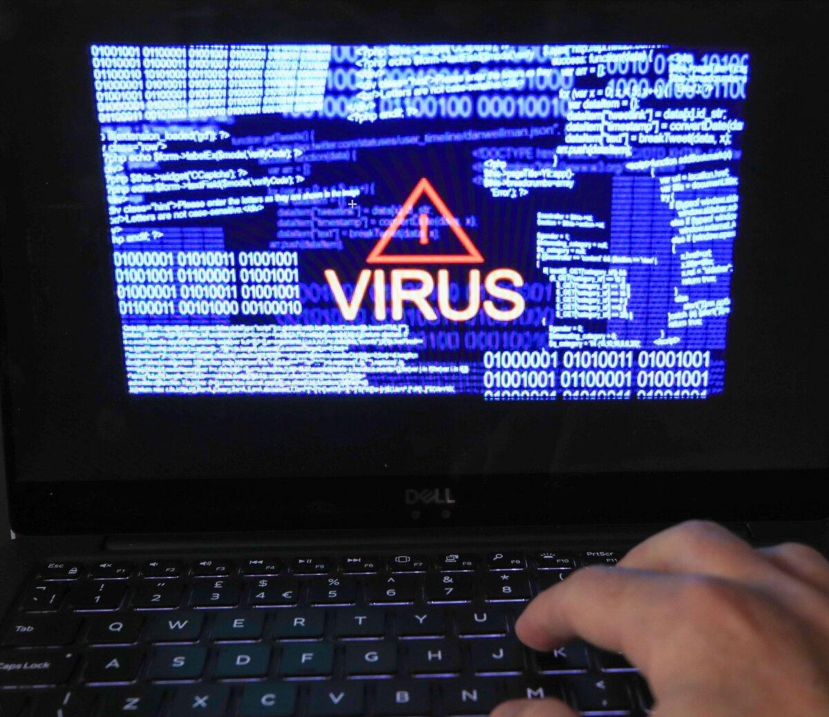 Cybersecurity Agents Accused of Working With Notorious Blackcat Hackers to Extort Firms | USNN World News Undated file photo showing a "virus" warning and binary codes on a computer screen. (Peter Byrne/PA)