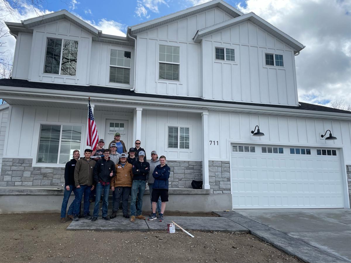 Murray High School students pose in front of 711 Bullion Street, the house they built. (Courtesy of Quinn Drury)