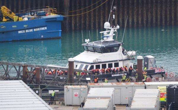 A group of people thought to be illegal immigrants are brought in to Dover, Kent, from a Border Force vessel following a small boat incident in the English Channel on March 30, 2024. (Gareth Fuller/PA Wire)