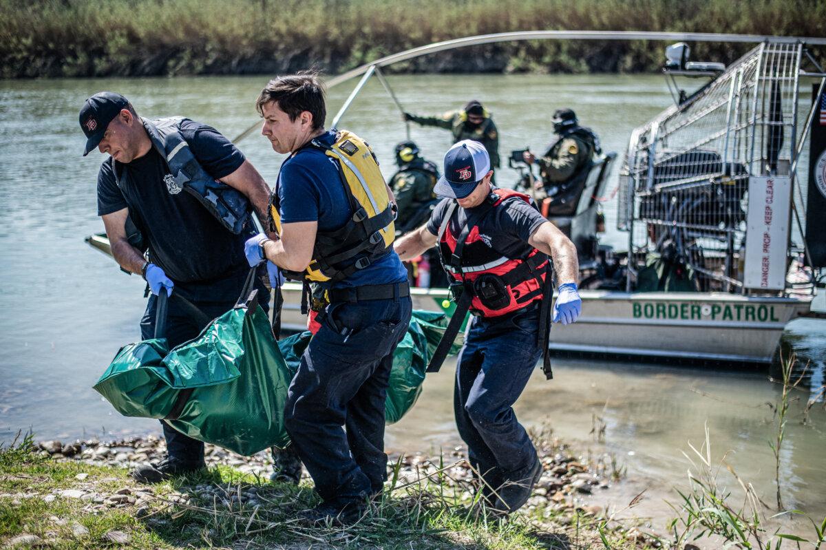 (L–R) Firefighters Rodrigo Pineda, William Dorsey, and Lt. Julio Valdes of the Eagle Pass Fire Department recover a body from the Rio Grande river in Eagle Pass, Texas, on March 1, 2024. (Sergio Flores/AFP via Getty Images)