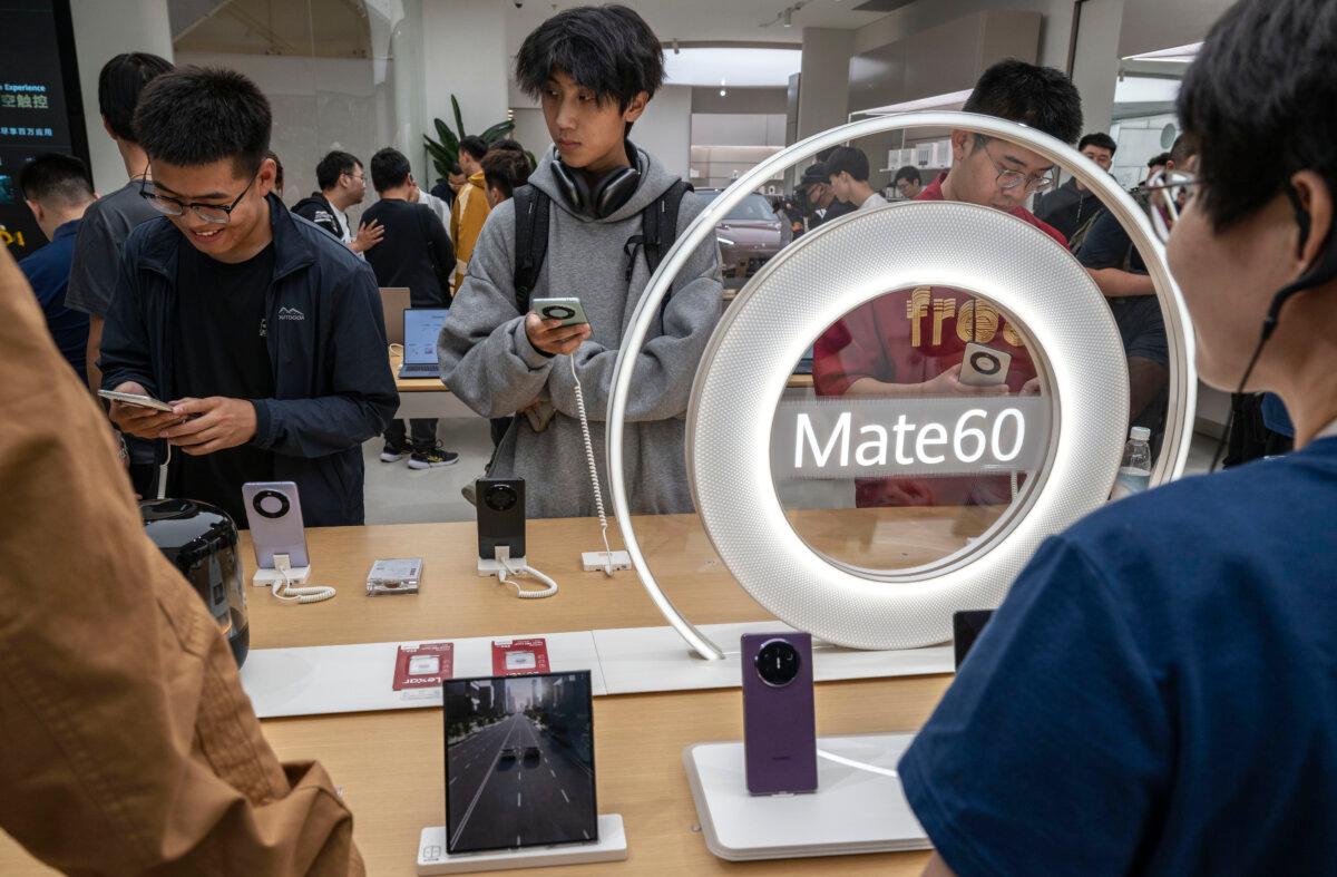 People look at newly launched smartphones at a Huawei flagship store in Beijing, China on Sep. 25, 2023. (Kevin Frayer/Getty Images)