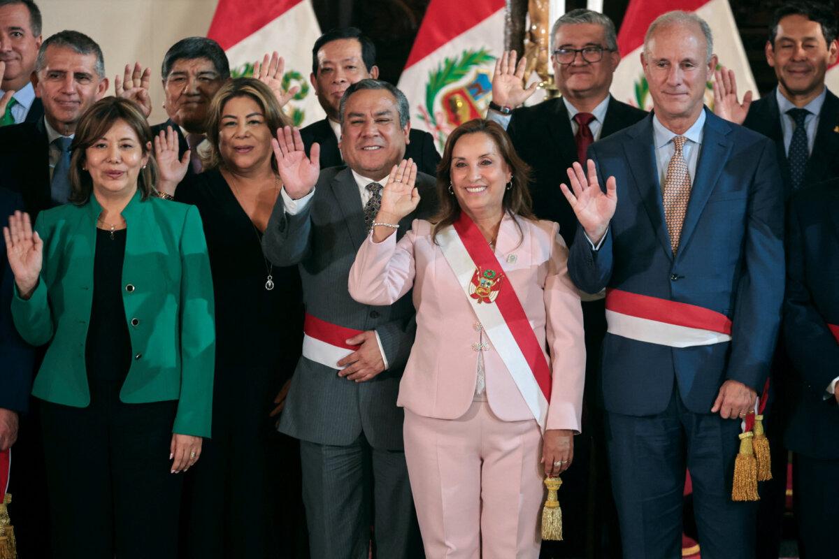 Peruvian President Dina Boluarte poses with her state ministers after swearing in a new cabinet in Lima, Peru, on April 1, 2024. (Sebastian Castaneda/Reuters)